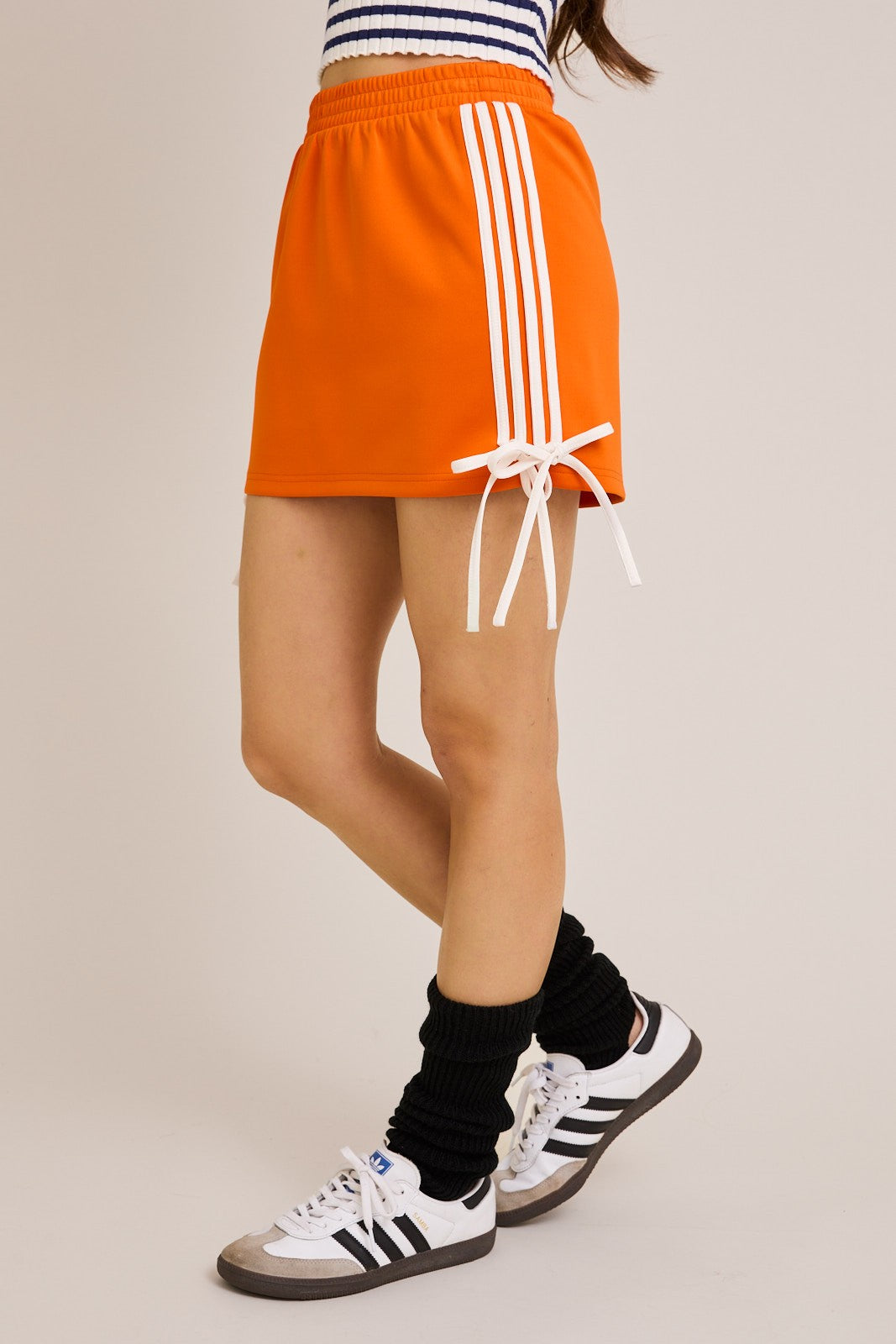 bow detail track mini skirt in orange and white
