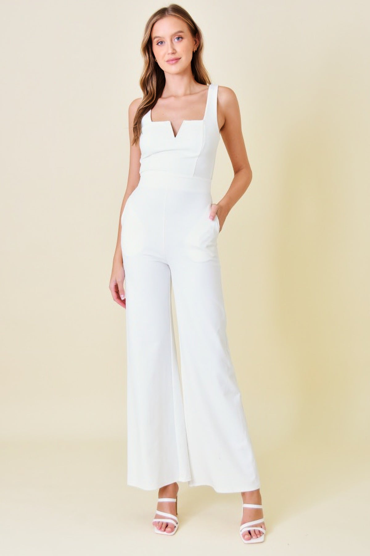 sleeveless fitted jumpsuit with pockets in ivory-front