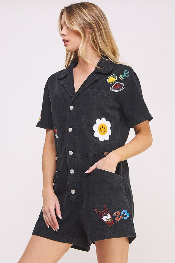 washed black short sleeve button down romper with patches-side