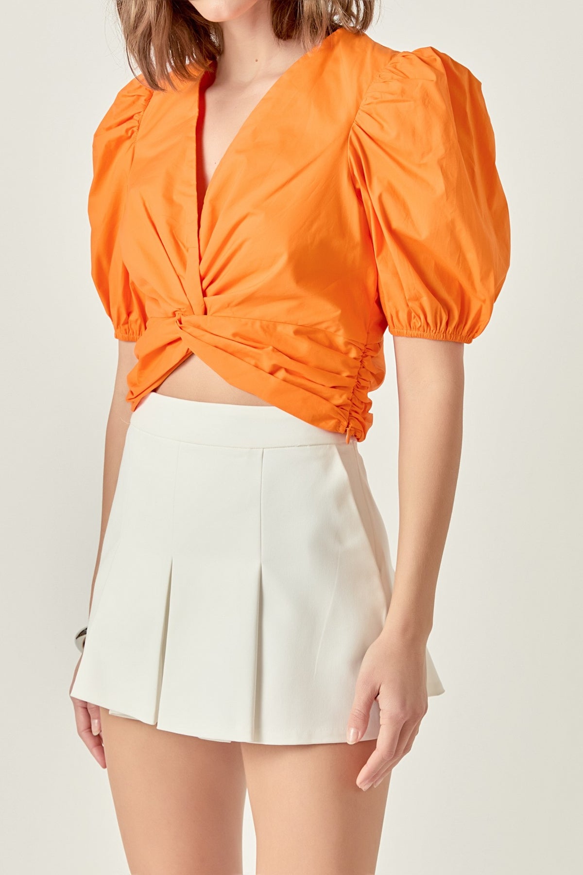 puff sleeve twist detail crop top in orange 