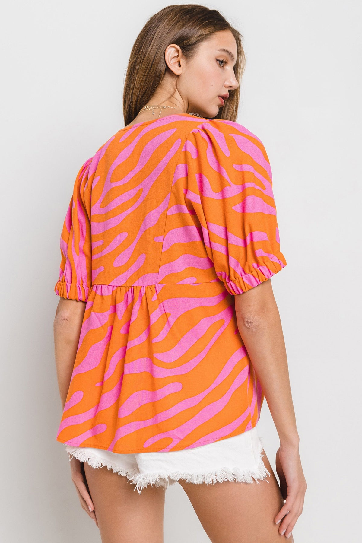 animal print v neck puff sleeve top in orange and pink-back