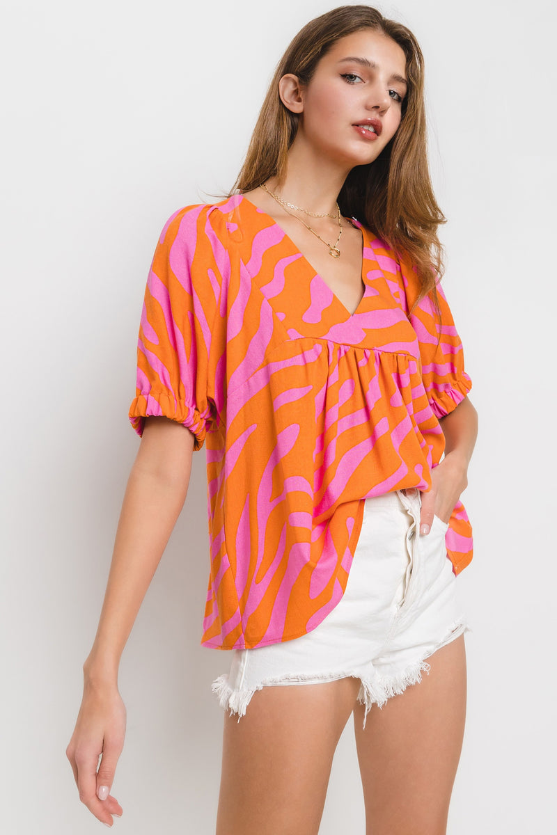 animal print v neck puff sleeve top in orange and pink-side
