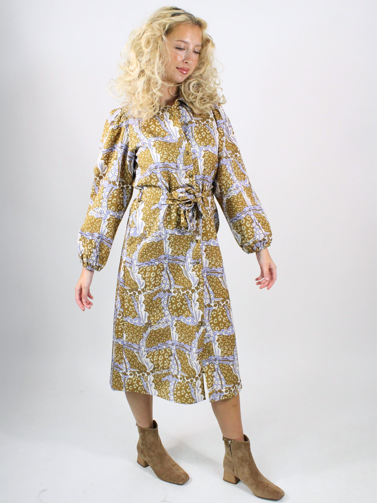 Woman wearing a patterned dress on a white background