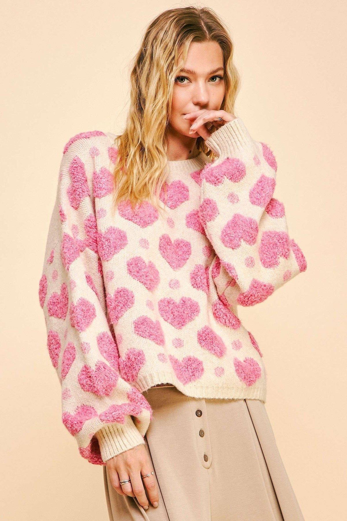 textured heart loose fit long sleeve knit sweater in pink-front