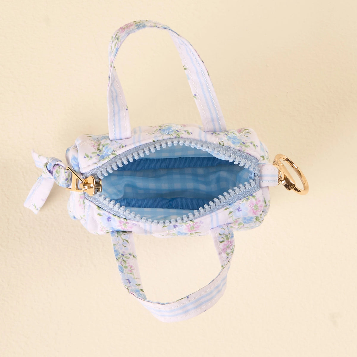 interior open bag Light Blue White Purple Floral Mini Duffle Bag Bag Charm on Cream Background Darling Effect Itty Bitty Duffle Bag Charm Petal Parade Blue