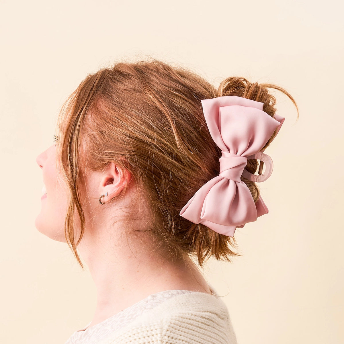 Girl wearing pink claw clip hair bow Darling Effect Satin Bow Claw Hair Clip Blush