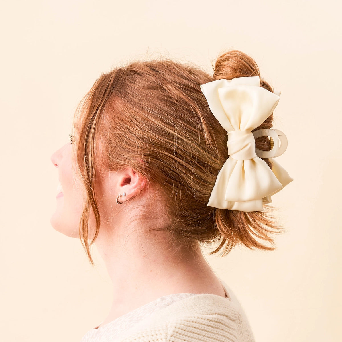 Girl wearing cream claw clip hair bow on cream background Darling Effect Satin Bow Claw Hair Clip Cream