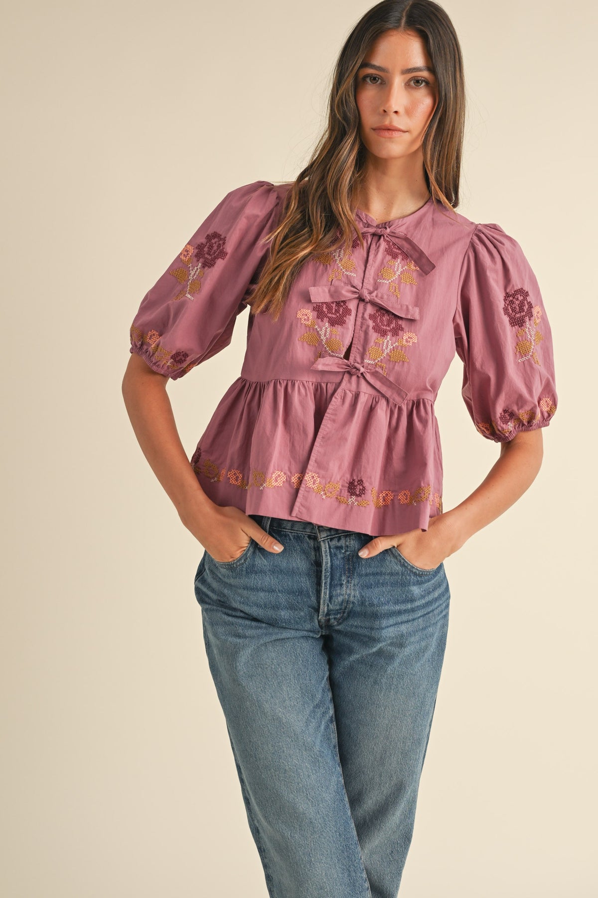 embroidered puff sleeve tie front peplum top in raspberry-front