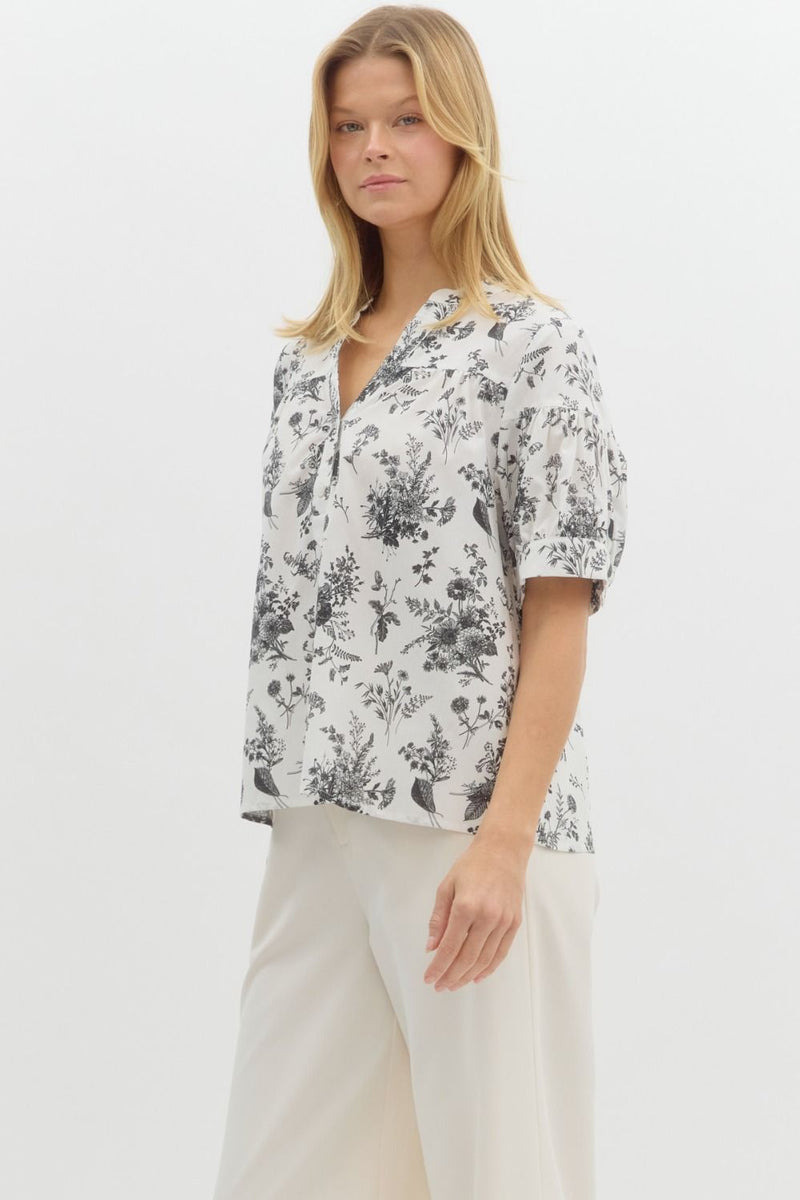 Floral print half button closure pullover top in black