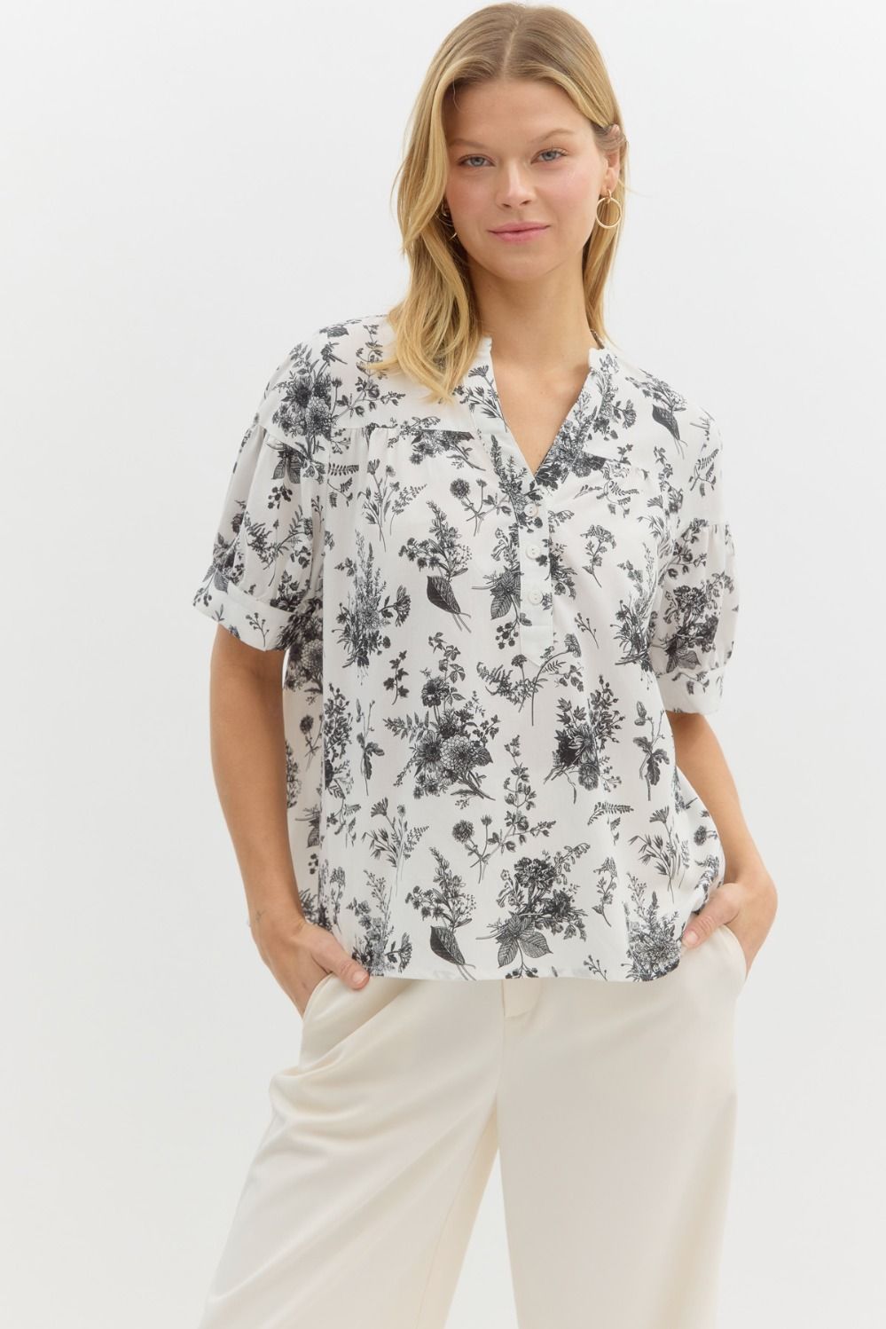 Floral print half button closure pullover top in black