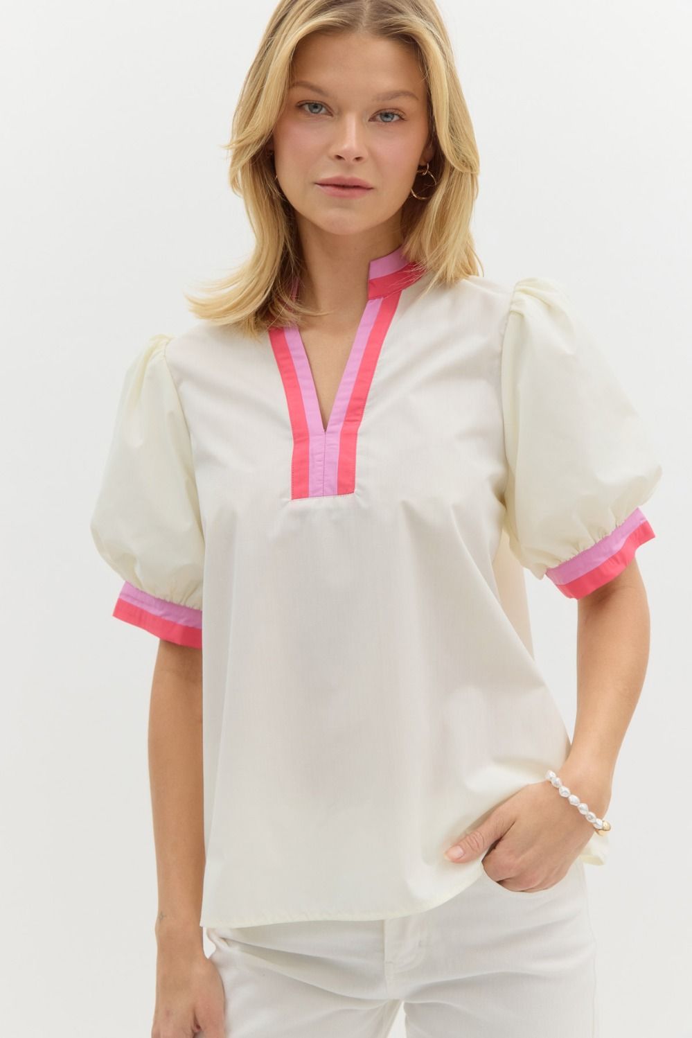 Solid short bubble sleeve top featuring multicolor band finish in white and pink