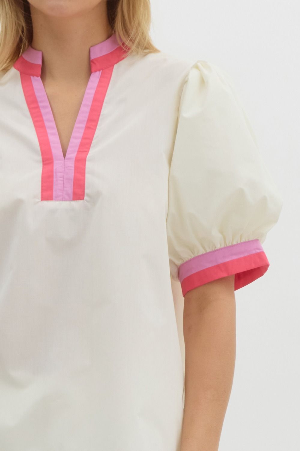 Solid short bubble sleeve top featuring multicolor band finish in white and pink