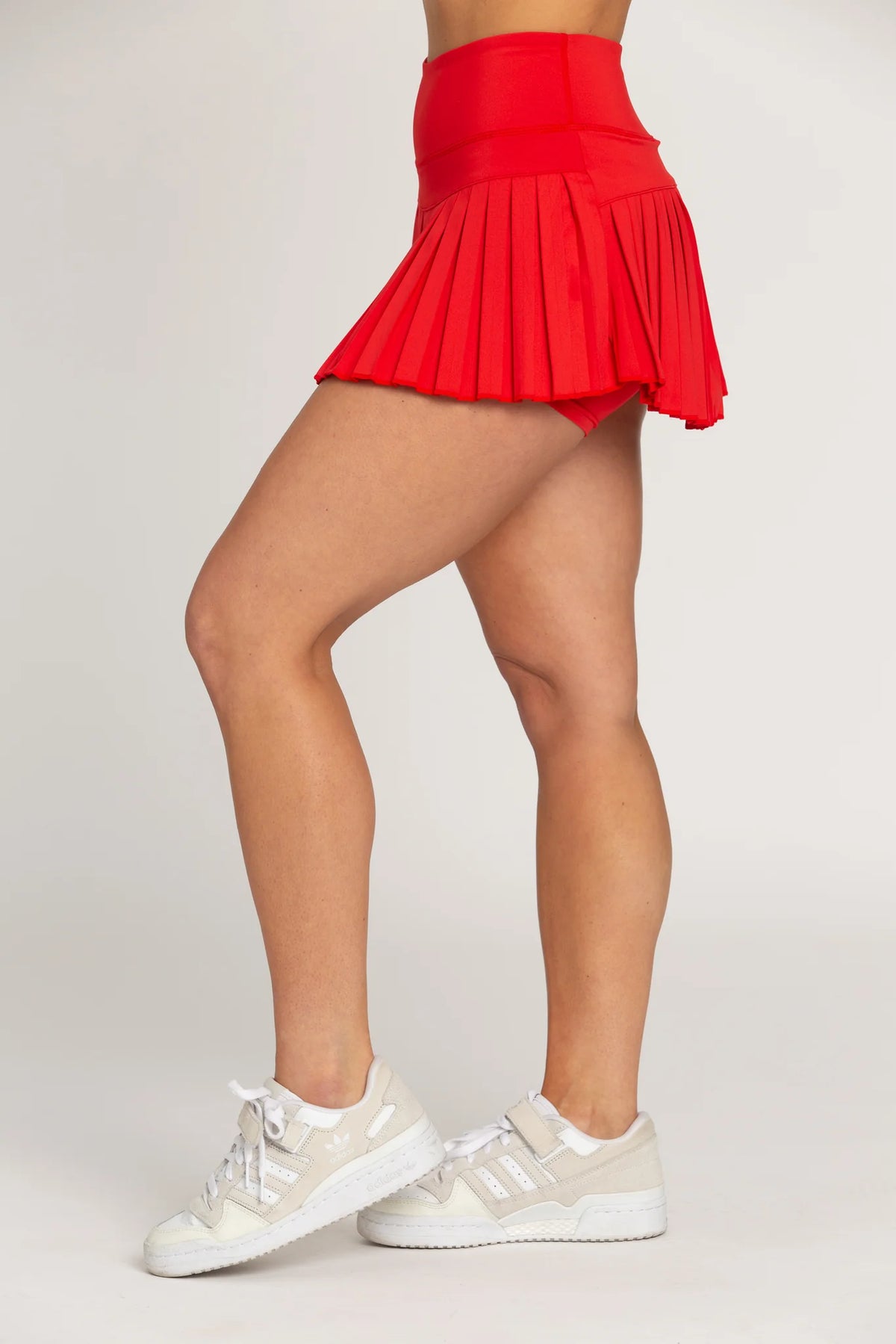 gold hinge pleated tennis skirt in candy red
