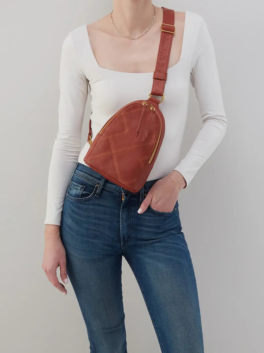 HOBO Fern Pebbled Leather Stitched Sling Bag in Rust