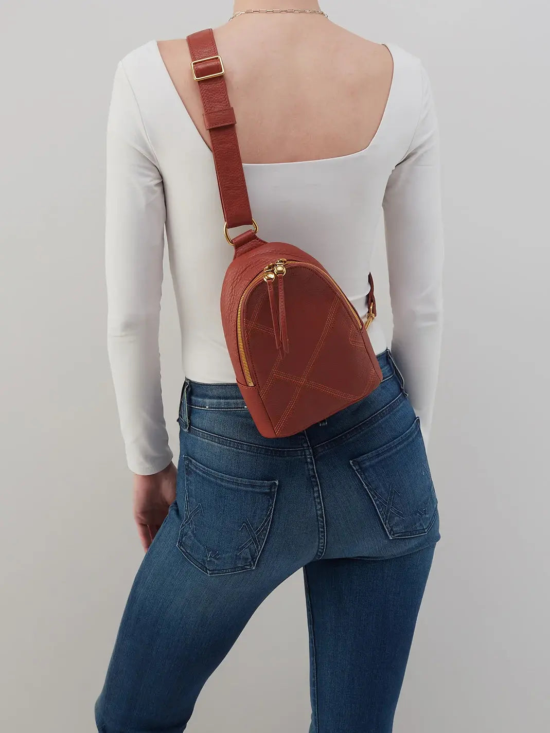 HOBO Fern Pebbled Leather Stitched Sling Bag in Rust