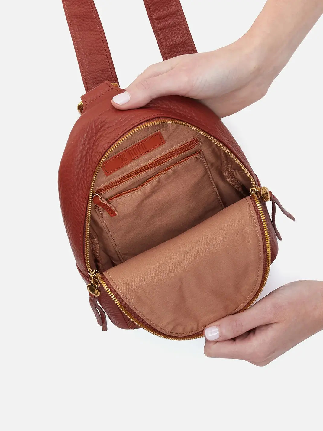 HOBO Fern Pebbled Leather Stitched Sling Bag in Rust