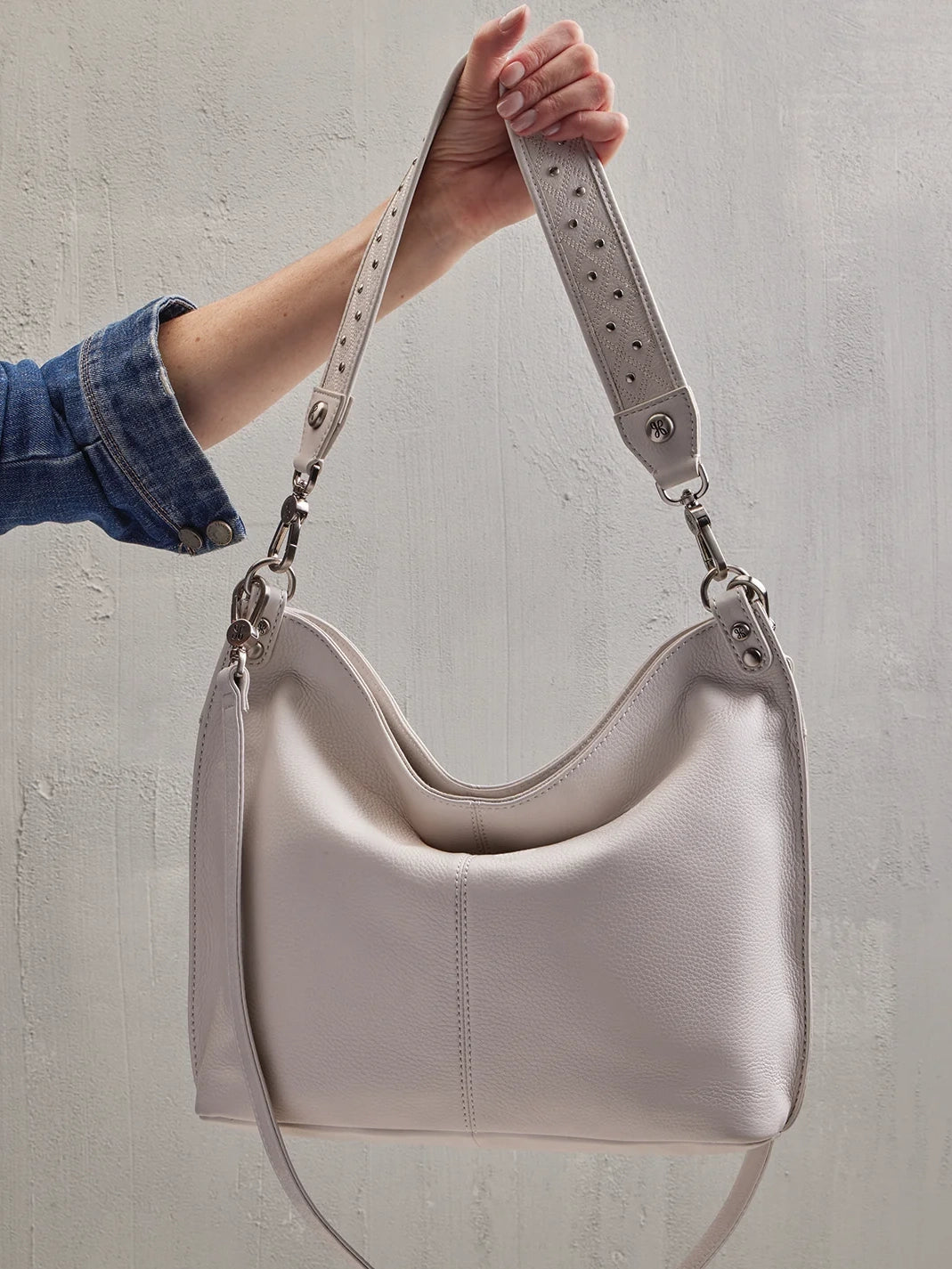 hobo pier studded shoulder crossbody pebbled leather in white-hanging view