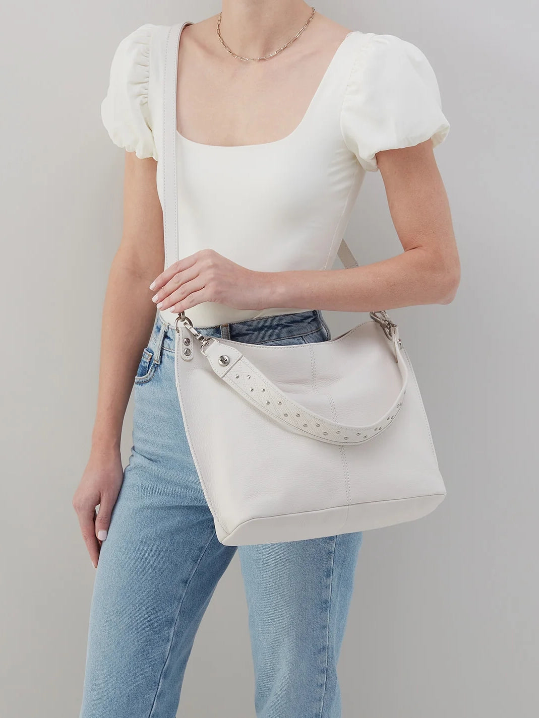 hobo pier studded shoulder crossbody pebbled leather in white-on model view