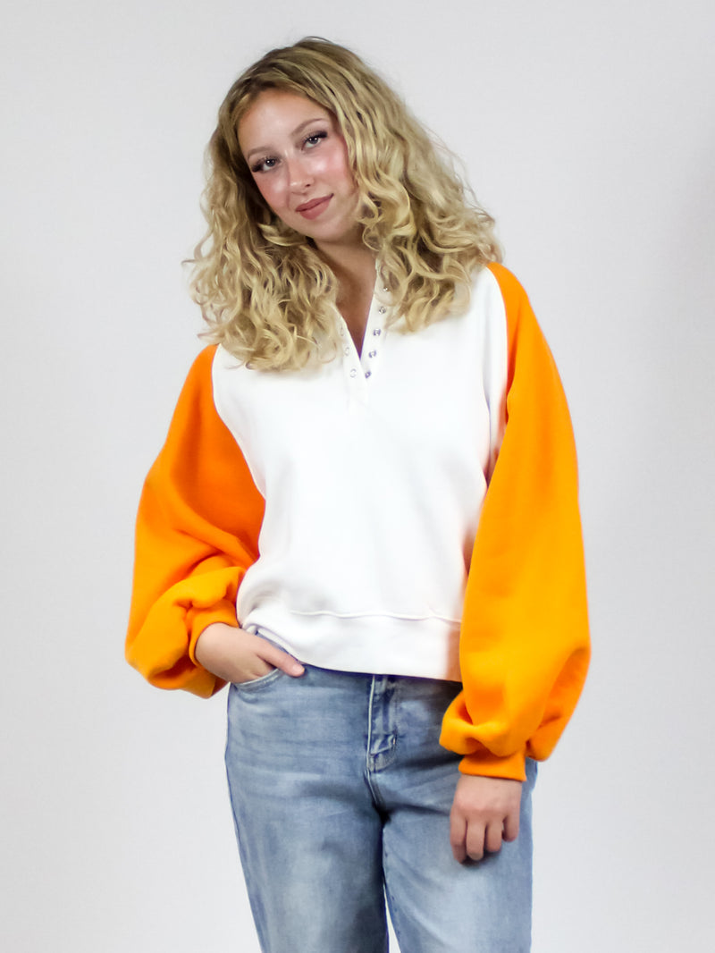 orange and white colorblock sweatshirt with snap button collar in orange and white-front