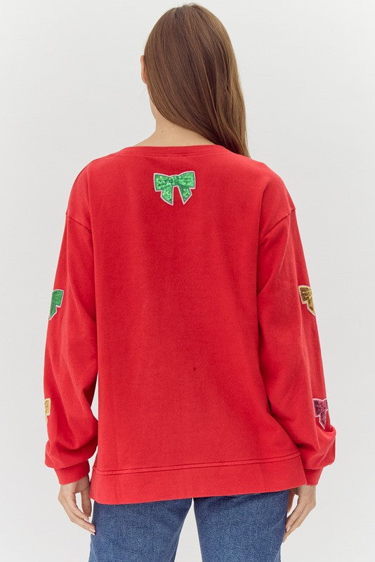 ribbons in sequins on a red sweatshirt-back