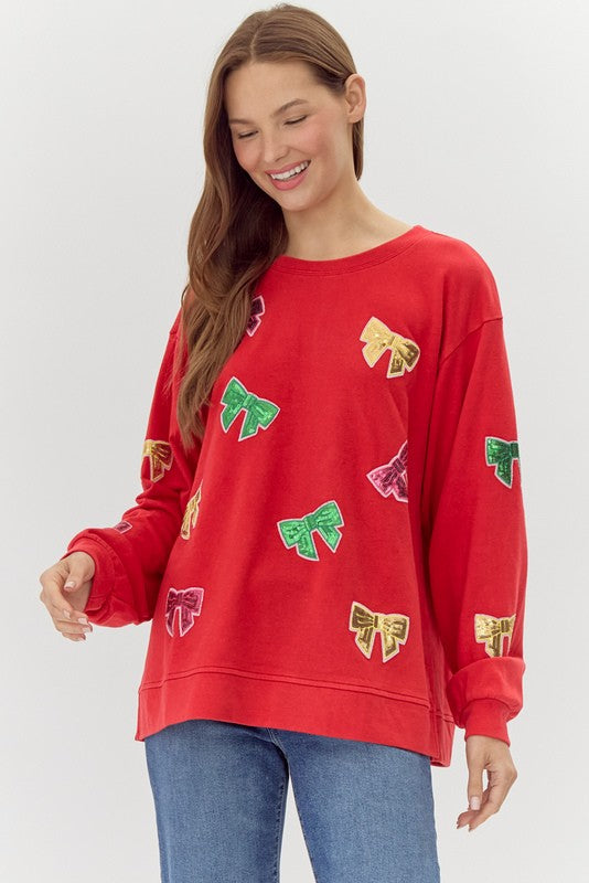 ribbons in sequins on a red sweatshirt-front