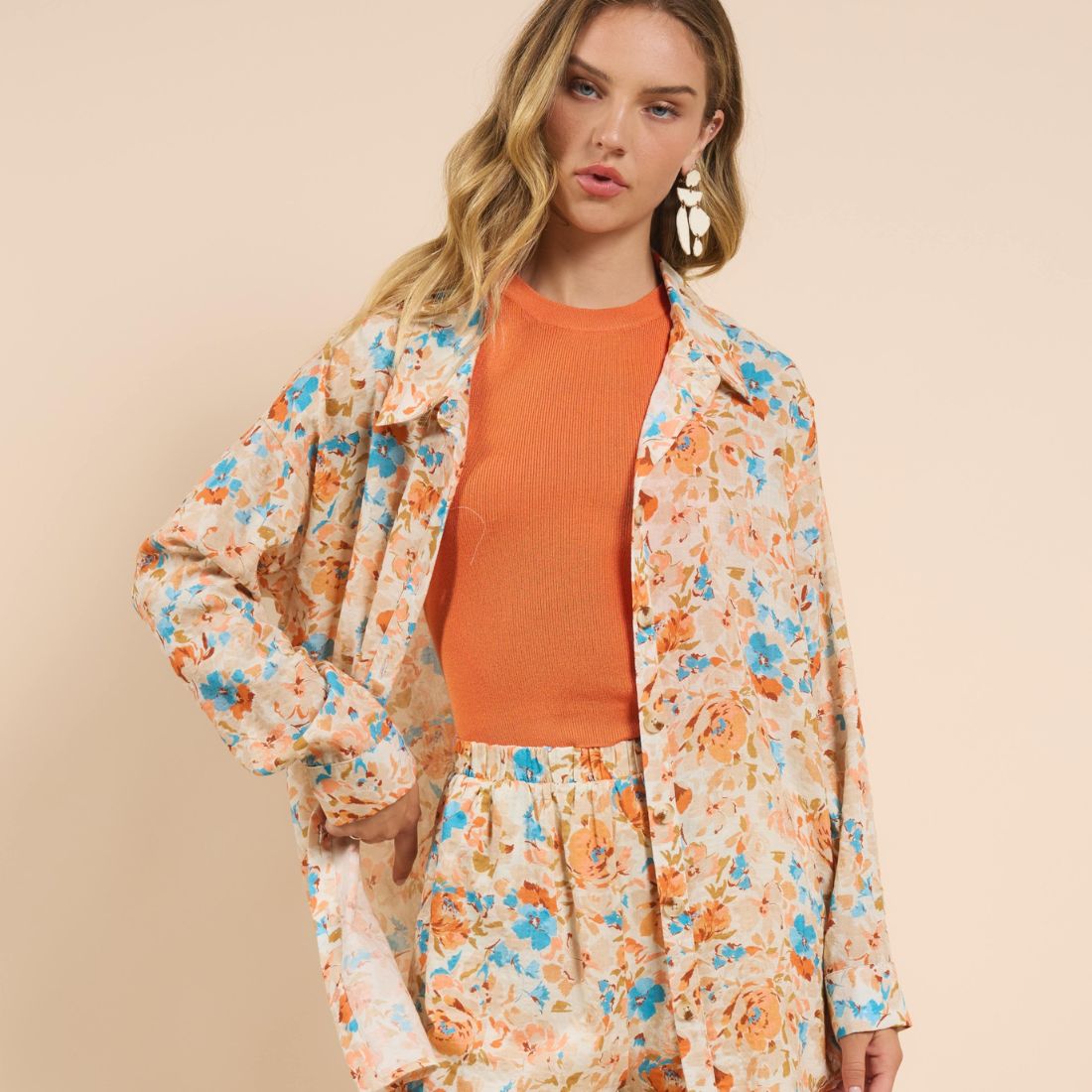 shop spring clothing tops and blouses at bliss knoxville model in orange and blue floral button down top