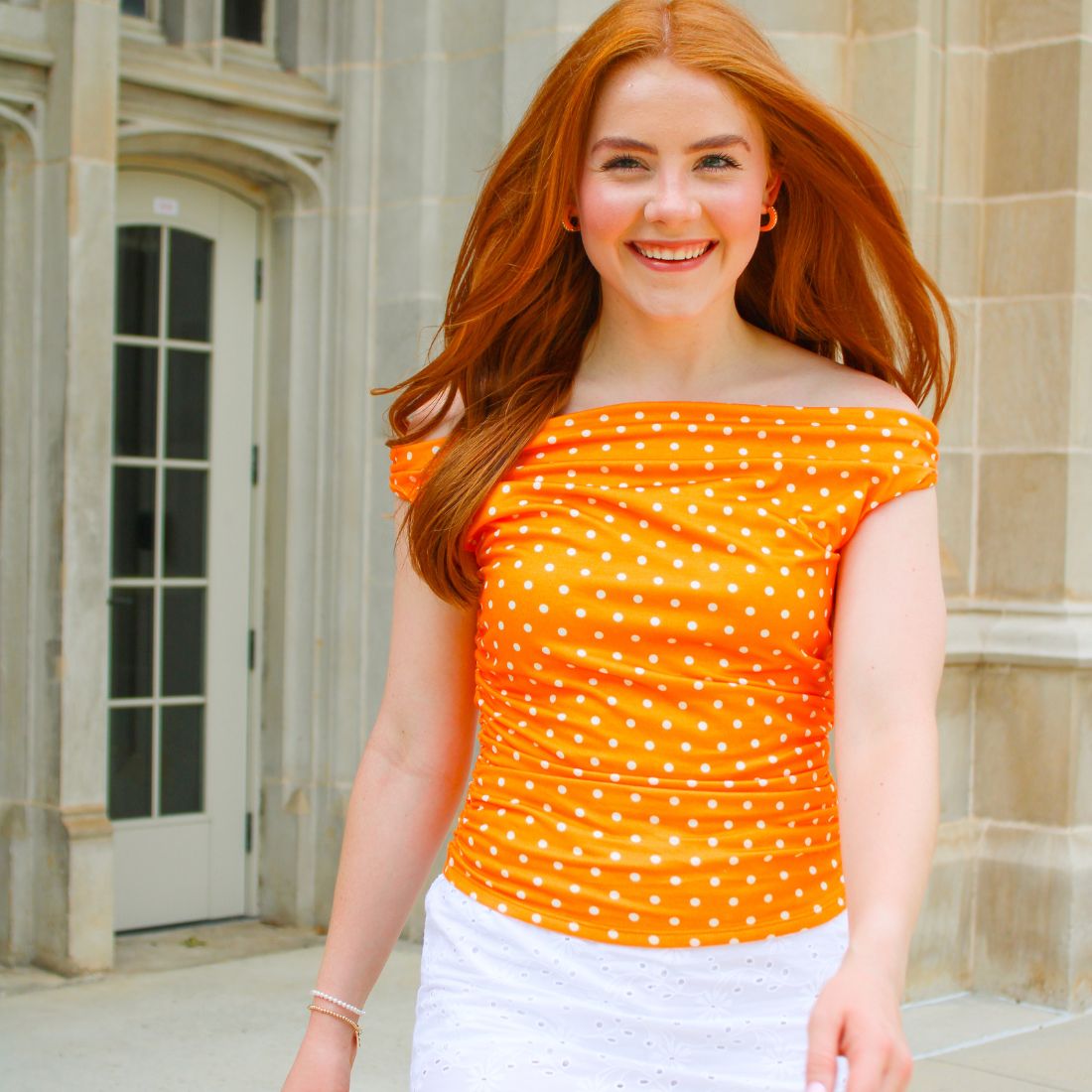 Shop Tennessee Volunteers Gameday Tops & Blouses at Bliss Knoxville. TN Vols Gameday Fashion Clothing for Women. Orange & White Polka Dot Off-The-Shoulder Ruched Top.