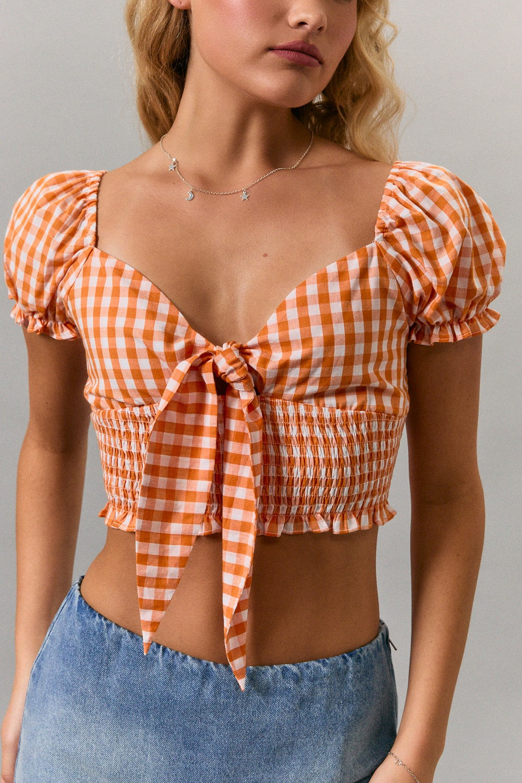 short puff sleeve gingham top with tie front in orange white checkerboard