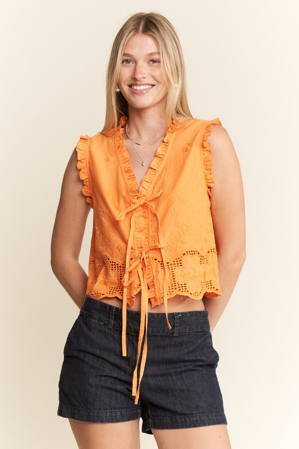 sleeveless ruffle tie top in orange