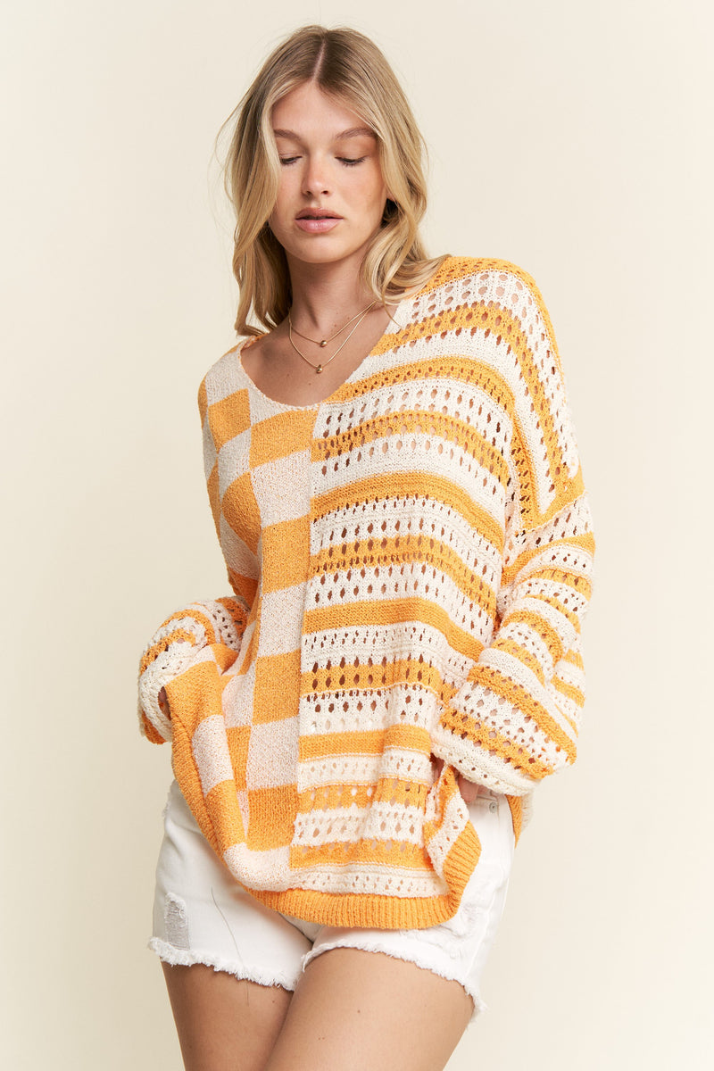 stripe and checkerboard crochet sweater in orange and white