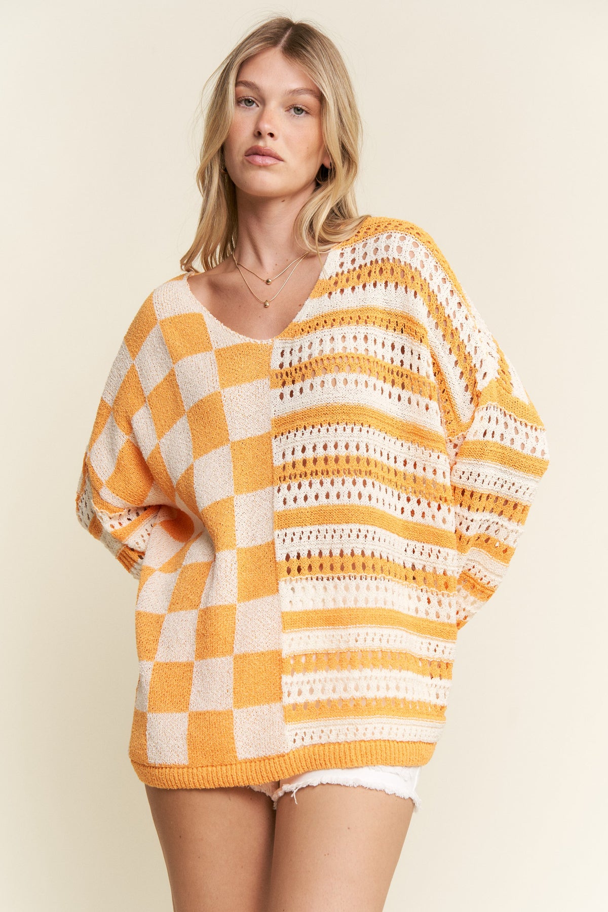 stripe and checkerboard crochet sweater in orange and white