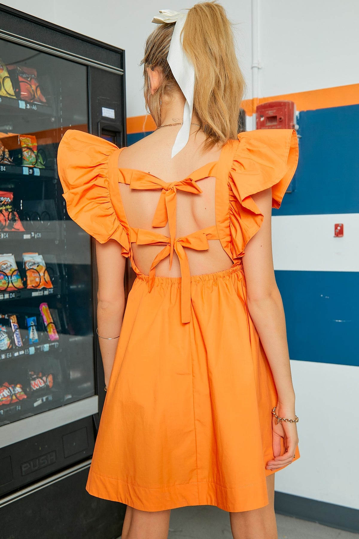 tennessee orange ruffle sleeve mini dress with tie back bow details in orange-back