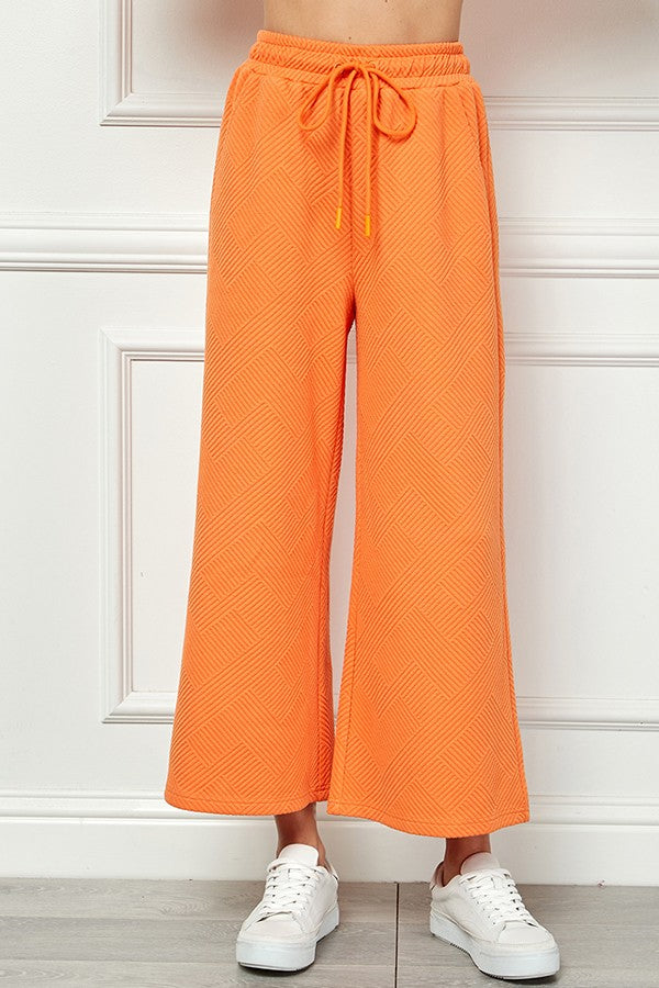 textured cropped wide leg pants in tangerine-front view
