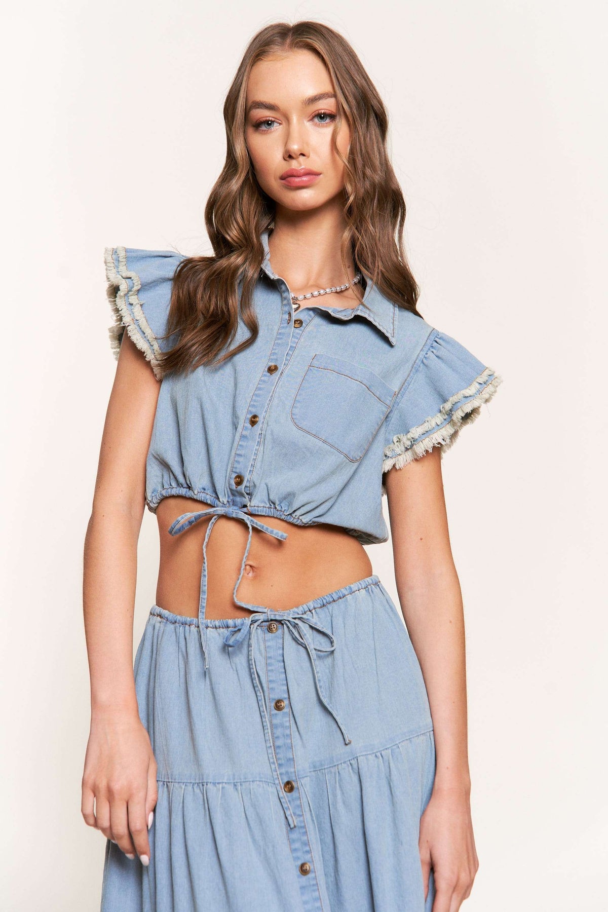 washed denim ruffle sleeve cropped button down top in denim blue-front
